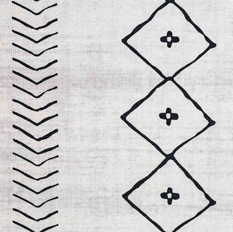 May include: Black and white geometric pattern rug with a chevron design on one side and a diamond pattern on the other side.