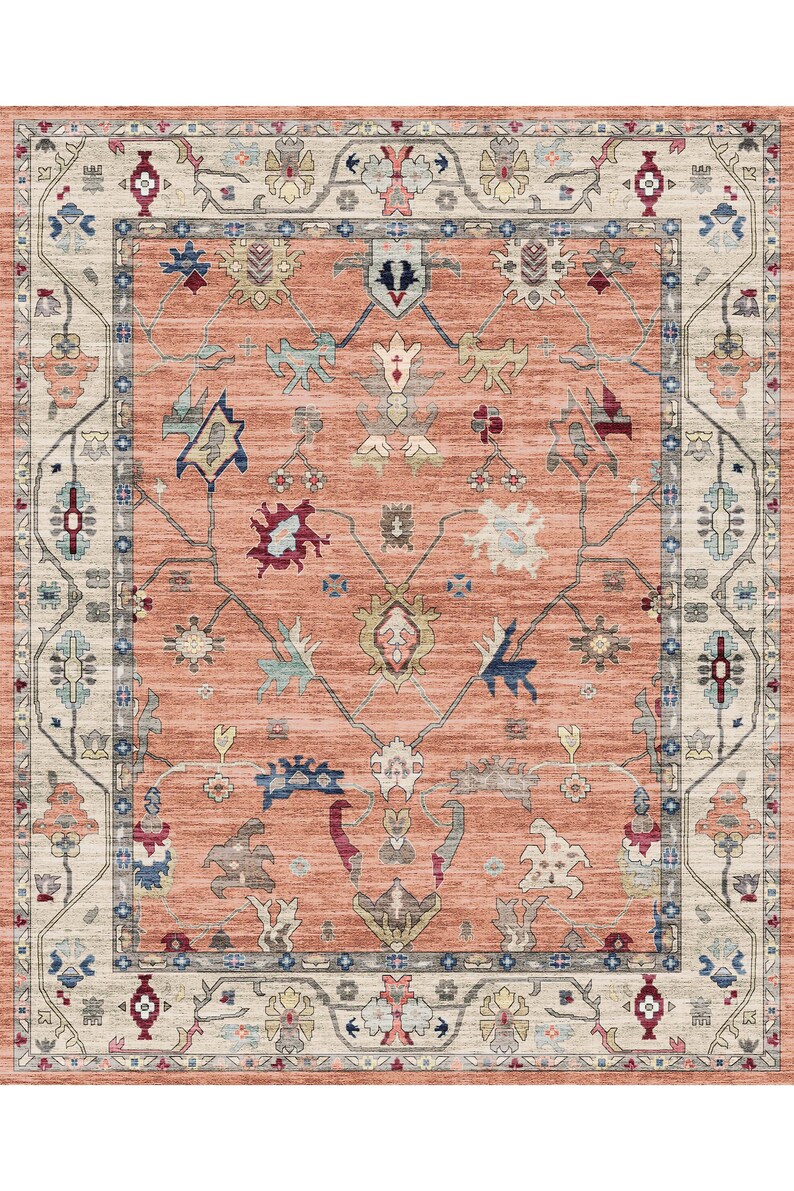 May include: A peach-colored rug with a traditional Persian design. The rug has a cream-colored border with intricate floral patterns. The center of the rug features a repeating pattern of stylized flowers and leaves.