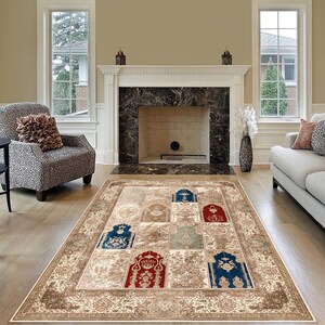 May include: A beige area rug with a patterned design featuring multiple arches in shades of blue, red, and green. The rug is laid out in a living room with a fireplace and two windows.