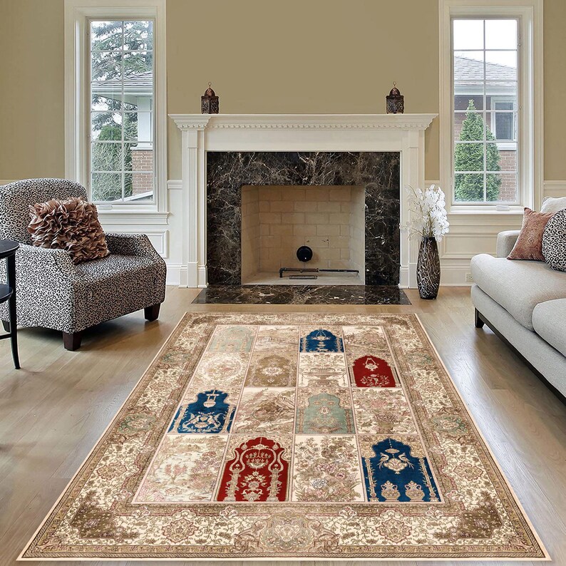 May include: A beige area rug with a patterned design featuring multiple arches in shades of blue, red, and green. The rug is laid out in a living room with a fireplace and two windows.