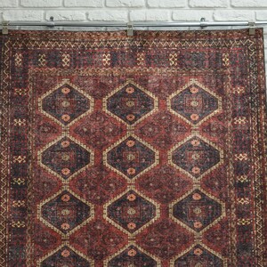 red afghan rug with geometric medallions