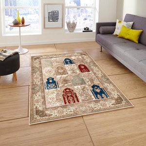 May include: A beige area rug with a patterned design featuring multiple arches in shades of blue, red, and green. The rug has a cream-colored background with a floral border.