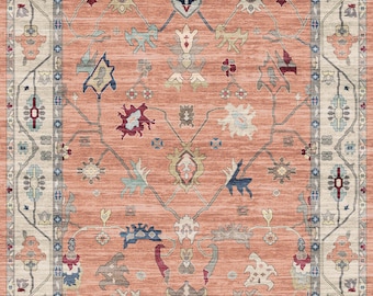 May include: A peach-colored rug with a traditional Persian design. The rug has a cream-colored border with intricate floral patterns. The center of the rug features a repeating pattern of stylized flowers and leaves.