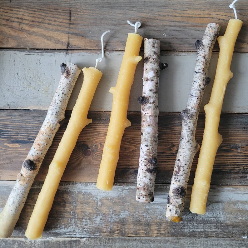 It shows real birch branches and taper candles