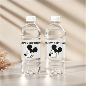 May include: Two clear plastic water bottles with white caps. Each bottle has a label with the text "HAPPY BIRTHDAY" and a black and white Mickey Mouse graphic. The bottles are filled with clear liquid.