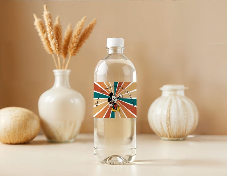 May include: A clear plastic water bottle with a white cap. The bottle has a colorful label featuring Mickey Mouse and the text "Oh boy, sounds like we've got a party!" Decorative vases and a sphere are in the background.