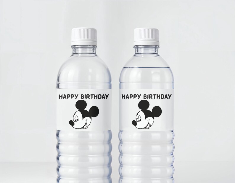 May include: Two clear plastic water bottles with white caps. Each bottle has a label with the text "HAPPY BIRTHDAY" above a black and white cartoon mouse face. The bottles are filled with clear liquid.