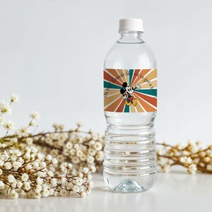 May include: Clear plastic water bottle with a white cap. The bottle has a label featuring Mickey Mouse with the text "Oh boy sounds like we've got a party". The label has a retro design with orange, teal, and brown rays.