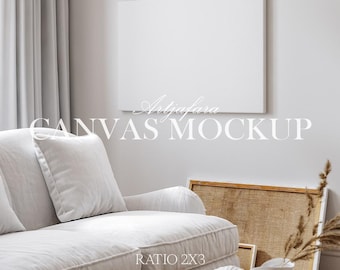 May include: A blank rectangular canvas mounted on a light wall above a white sofa with cushions. The image includes the text Artjafara CANVAS MOCKUP and RATIO 2X3 with icons for JPG and PSD files. A textured brown frame leans against the wall.