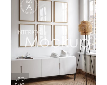 May include: A white wall with four gold picture frames, a white cabinet with three drawers, a black floor lamp with a woven shade, and a white wall with the text "INTERIOR MOCKUP" in black.