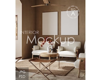 May include: Two white armchairs with wooden frames and a brown woven coffee table in a living room with a brown wall and a beige rug. Two blank white frames hang on the wall. The text "INTERIOR MOCKUP" is written in white on the wall. The text "JPG PSD" is written in black on the wall.