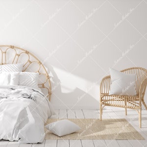 May include: A white bed with a woven headboard and a white blanket. A wicker chair with a white pillow sits on a beige rug in front of the bed.