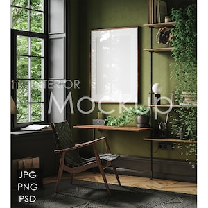 May include: A home office interior with a green wall, a black chair, a wooden desk, a framed poster, a shelf with plants and books, and a black lamp.