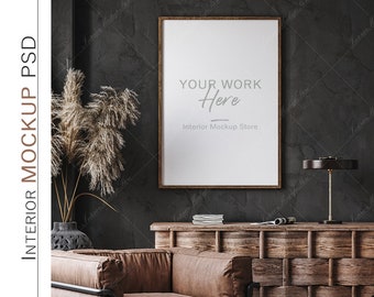May include: Interior mockup featuring a framed poster with the text "YOUR WORK Here" and "Interior Mockup Store". The poster is mounted on a dark gray textured wall. A wooden cabinet, a lamp, and a leather sofa are also visible.