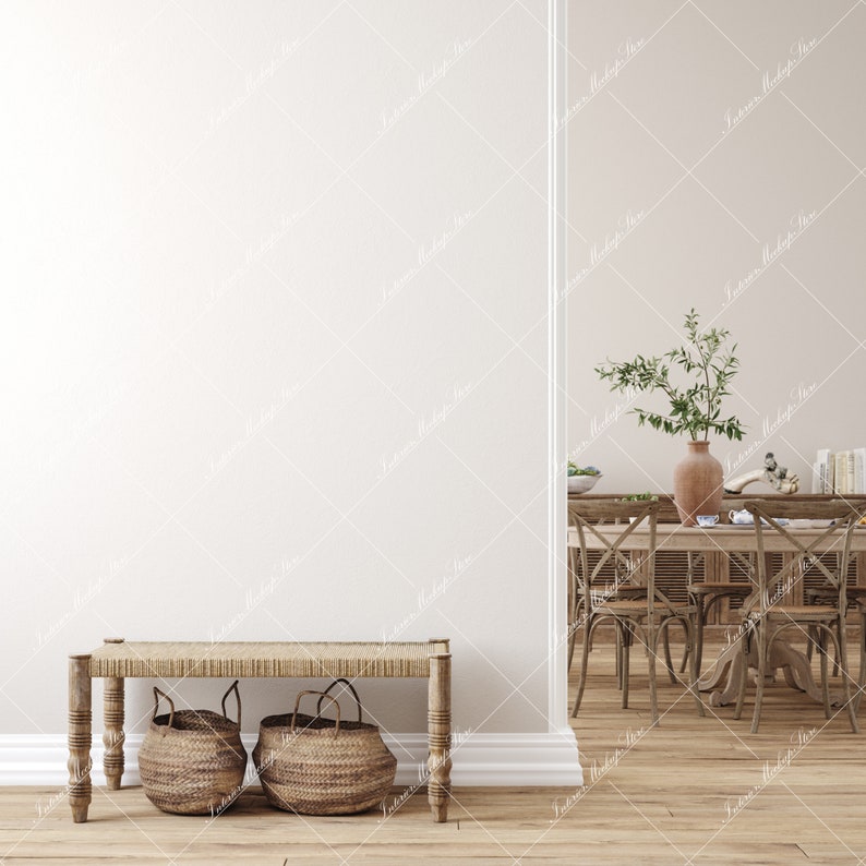 May include: A wooden bench with a woven seat and two woven baskets underneath. The bench is in front of a white wall and a doorway leading to a dining room with a wooden table and chairs.