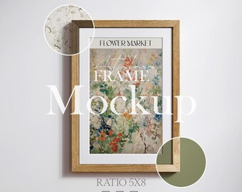 May include: A vertical wooden picture frame containing a print with the text FLOWER MARKET at the top. The artwork features a colorful floral pattern with red, blue, and green botanical elements. The frame has a light brown wood grain texture.