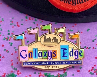 The Edge of the Galaxy Enamel Pin (Galaxy’s Edge x Disneyland retro sign crossover design)