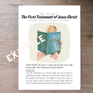 May include: A printed page with the text "The First Testament of Jesus Christ" and "Introduction to the Old Testament." An illustration shows a child reading a book labeled "Old Testament." The text includes a Bible verse and a prompt to learn about Jesus.