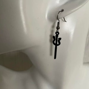May include: Black trident earrings with a silver hook. The earrings are on a white mannequin head.