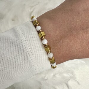 Contrasting elegance: bracelet made of golden hematite cubes and white agate beads