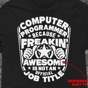 May include: Black t-shirt with white text that reads "Computer Programmer Because Freakin' Awesome Is Not An Official Job Title". The text is in a bold, blocky font and is surrounded by a white border. The text is centered on the shirt. The shirt is designed to be easy to weed.