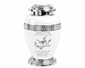 May include: A white cremation urn with silver-toned metal accents on the lid and base. The urn features an engraved robin on a branch, the name Margaret Anne Collins, dates 22-5-1955 to 2-11-2025, and the text Loving Mum, When robins appear, It's a sign you are near, Watching over us with love, Forever in our hearts.