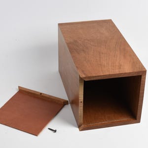 May include: A wooden box with a hinged lid. The lid is open and the inside of the box is visible. The box is made of a light brown wood with a natural finish.