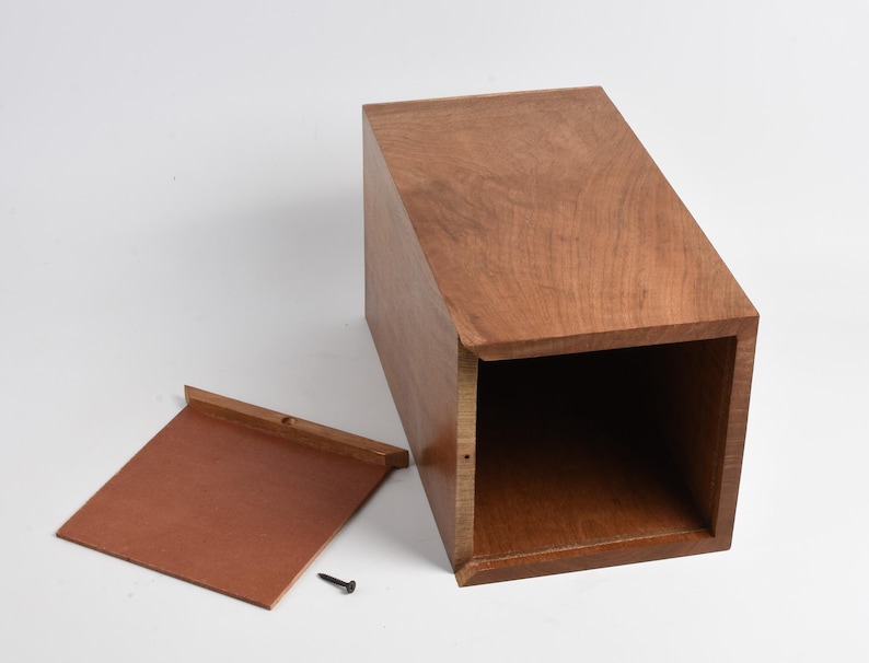 May include: A wooden box with a hinged lid. The lid is open and the inside of the box is visible. The box is made of a light brown wood with a natural finish.