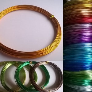 May include: Assortment of colourful aluminium wire in various colours, including gold, red, purple, blue, green, and silver. The wire is wound into coils and is ideal for crafting projects.