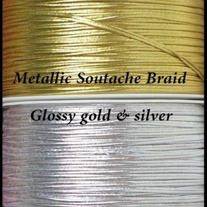 May include: Two spools of metallic soutache braid. The top spool is gold and the bottom spool is silver. The text "Metallic Soutache Braid" is printed on a white label above the gold spool. The text "Glossy gold & silver" is printed on a white label above the silver spool.