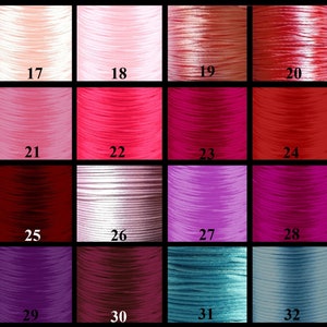 May include: A colour chart of 16 different shades of cord, ranging from light pink to dark purple. The cords are numbered 17 through 32.