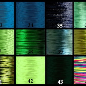 May include: A selection of 12 spools of waxed cotton cord in various colours, including teal, green, and black. The spools are numbered 33 through 44.
