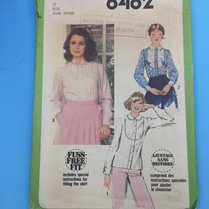 May include: Simplicity sewing pattern number 8482 for a miss or jeune femme. The pattern includes instructions for a shirt with a fuss-free fit. The pattern is not returnable if broken.