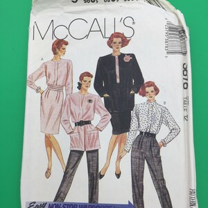 May include: A sewing pattern for three different outfits. The pattern is for size 12 and is called "Easy Non-Stop Wardrobe". The outfits include a pink dress, a pink jacket with black pants, and a black and white polka dot shirt with black pants.