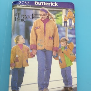 May include: A sewing pattern for a brown cardigan with a plaid trim. The pattern is from Butterick and is called "Thread Bare". The pattern includes sizes for children and adults.