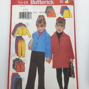 May include: A sewing pattern for kids clothing, featuring a red jacket, blue jacket, yellow skirt, red skirt, and pants. The pattern number is 5648 Butterick Kids Fashion Essentials. The size is 6-7-8.