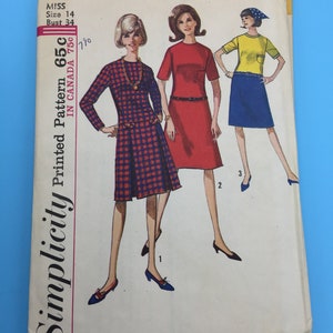 May include: Simplicity sewing pattern number 650 for a dress. The pattern is for a miss size 14 with a bust measurement of 34 inches. The pattern shows three different styles of dresses, one with a plaid print, one in red, and one in yellow. The pattern is printed on white paper with black text.