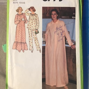 Könnte beinhalten: Simplicity-Schnittmuster 8773 für Miss Jeune Femme. Das Muster zeigt Illustrationen eines langen rosa Bademantels und Pyjamas. Auf der Vorderseite des Musters ist eine Frau in einem rosa Bademantel mit handschriftlichen Notizen zu sehen.