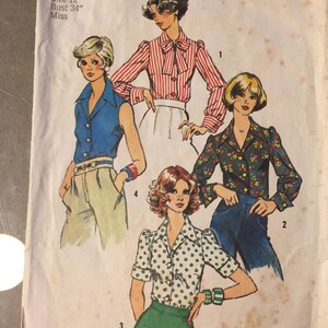 May include: Vintage Simplicity sewing pattern 6161 showing four blouse designs. The illustrations depict blouses with different styles, including a striped bow blouse, a floral print blouse, and a polka dot blouse. The pattern is size 12, with a 86 cm bust.