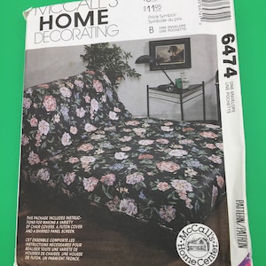 May include: A McCall's Home Decorating pattern package with instructions for making chair covers, a futon cover, and a shirred panel screen. The pattern is for a floral design with pink, white, and green flowers on a black background.