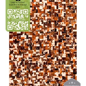 May include: A brown, white and black patchwork cowhide rug with a square pattern. The rug has a tag that says "SOUTHERNHIDES PREMIUM QUALITY GUARANTEED - "