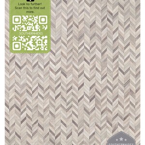 May include: A close-up of a chevron patterned rug made of leather. The rug is light brown and gray with a subtle sheen. The rug is made of high-quality leather and is guaranteed to be durable. The rug is perfect for adding a touch of luxury to any room.