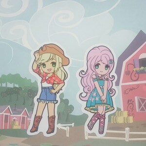 May include: Two cartoon girls, one with blonde hair wearing a red and white plaid shirt, blue jeans, and a brown cowboy hat, and the other with pink hair wearing a blue dress with a butterfly design. Both girls are smiling.