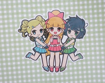 May include: Three cartoon girls with blonde, red, and blue hair are holding hands and smiling. They are wearing colorful outfits and are standing on a green and white checkered background.
