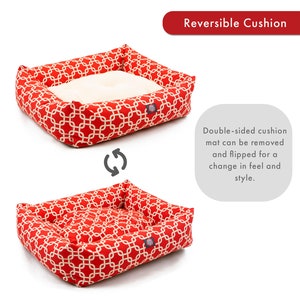 May include: Red and white patterned dog bed with a reversible cushion. The cushion can be removed and flipped for a change in feel and style.
