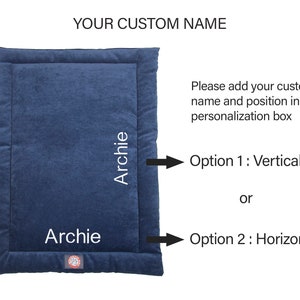 May include: A blue rectangular pet bed with a white border and the name "Archie" embroidered on it in two different positions. The text "YOUR CUSTOM NAME" is at the top of the image. The text "Please add your custom name and position in the personalization box" is below the bed. The text "Option 1: Vertical" and "Option 2: Horizontal" are below the text.