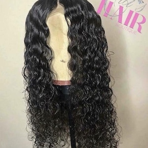 May include: A black curly human hair wig on a wig stand. The wig has a lace front and is styled in loose curls.