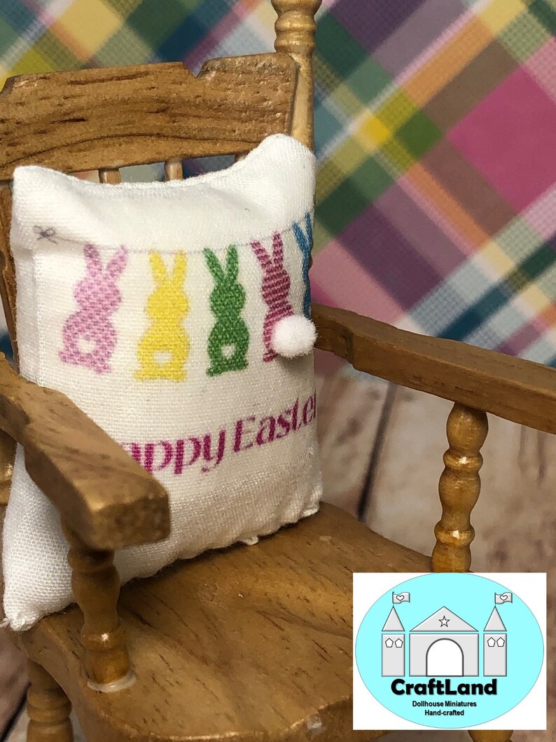 May include: A white pillow with a colorful Easter bunny design and the text "Happy Easter" on a wooden rocking chair.