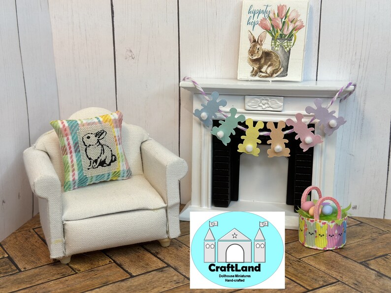 May include: A miniature dollhouse living room with a white armchair, a pillow with a bunny design, a fireplace with a garland of pastel bunny cutouts, and a basket filled with colorful Easter eggs.