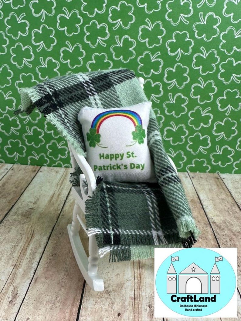 May include: A white rocking chair with a green and black plaid blanket and a white pillow with a rainbow and the text "Happy St. Patrick's Day".